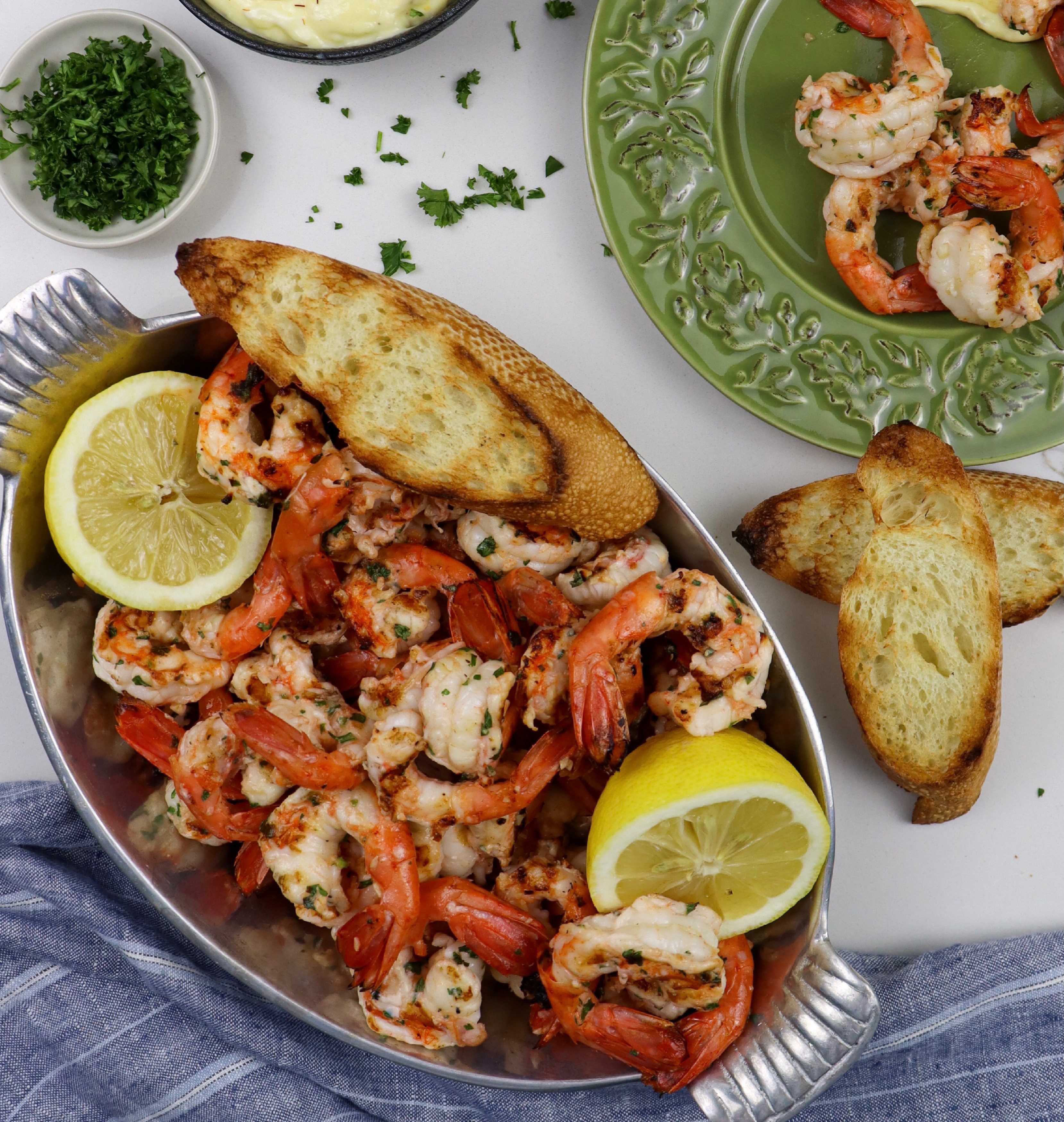 Dish of grilled spot prawns and plate of prawns