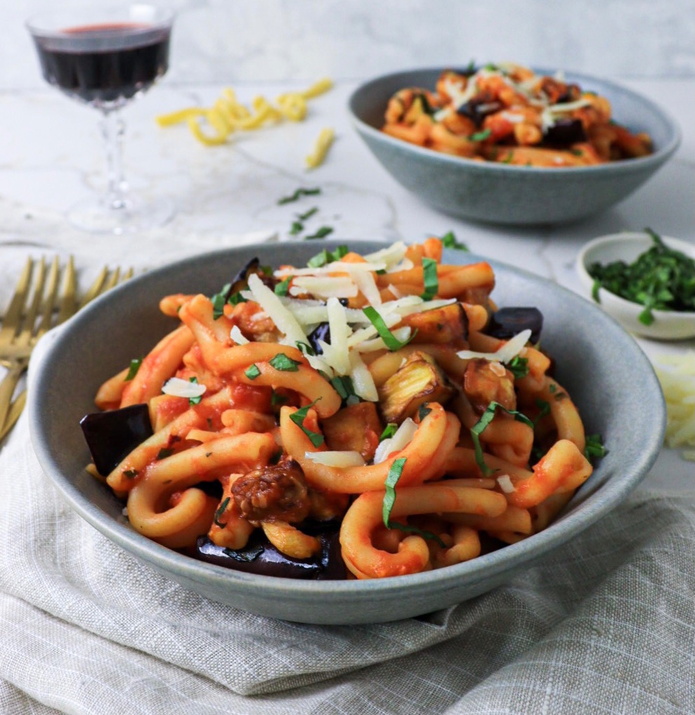 Two bowls of pasta alla norma