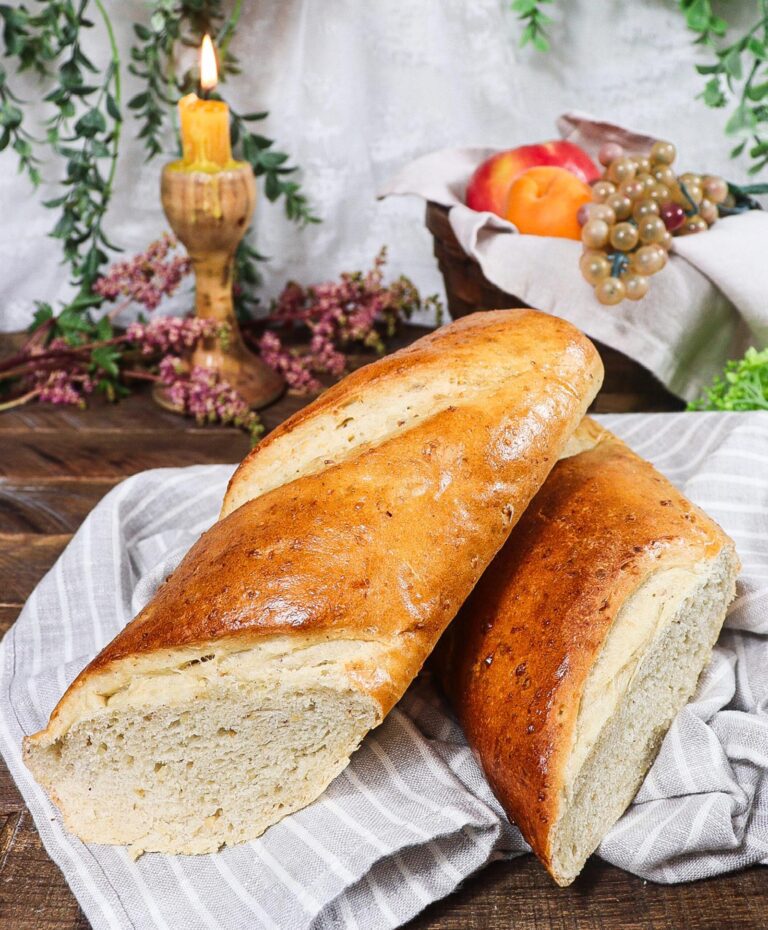 A baguette of Hazelnut bread cut in half