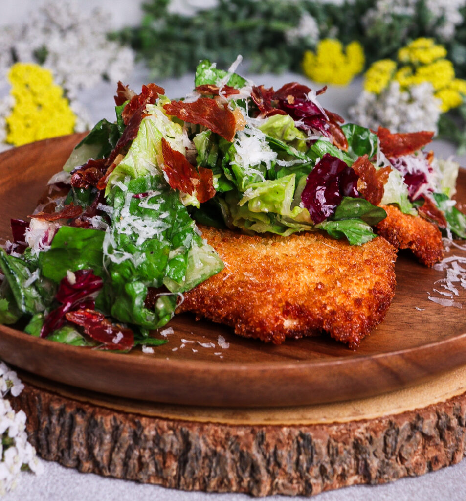caesar salad crispy chicken, caesar salad with prosciutto, chicken milanese with caesar salad