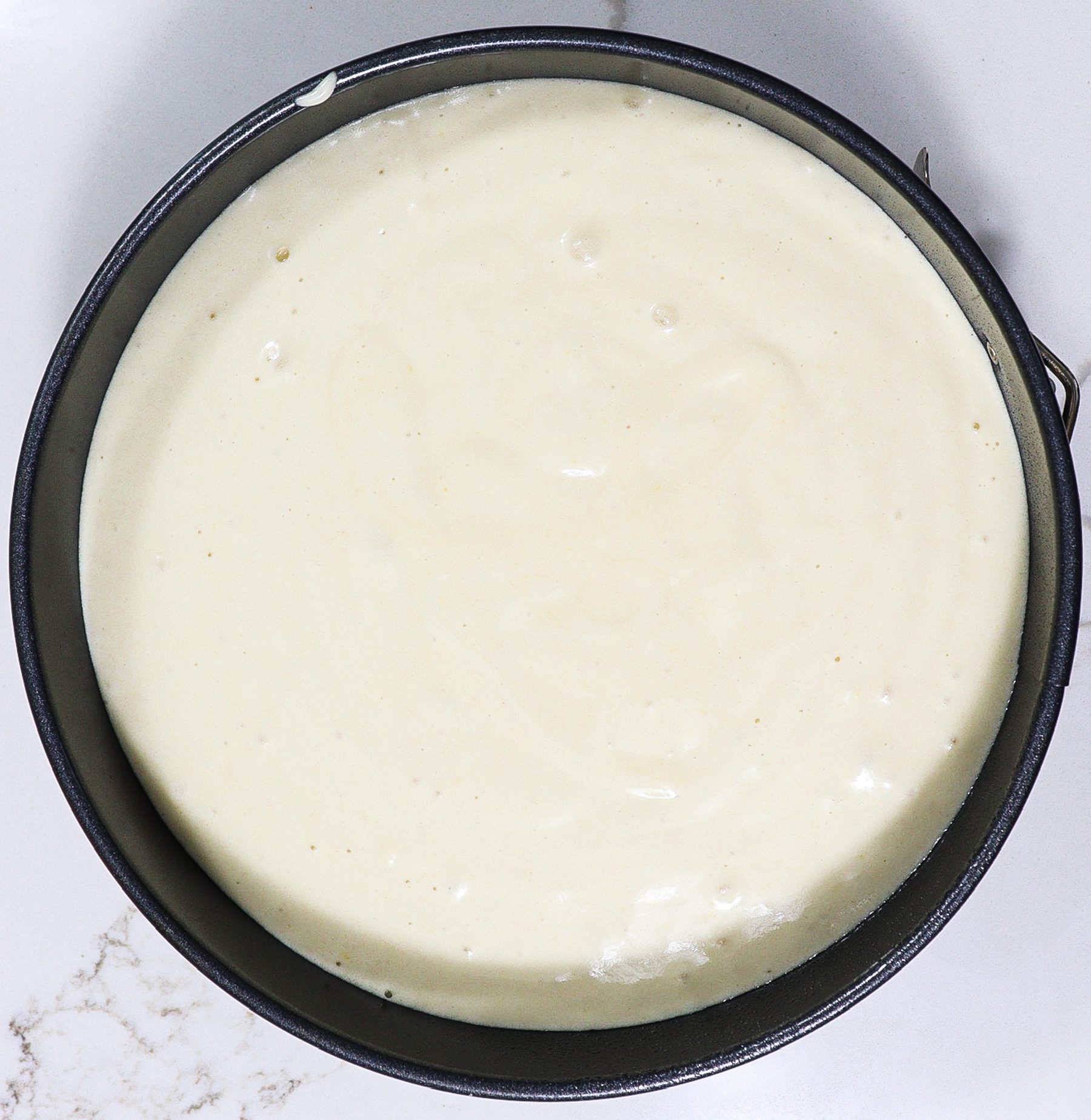 meadowsweet cream cake batter in a round cake pan before baking